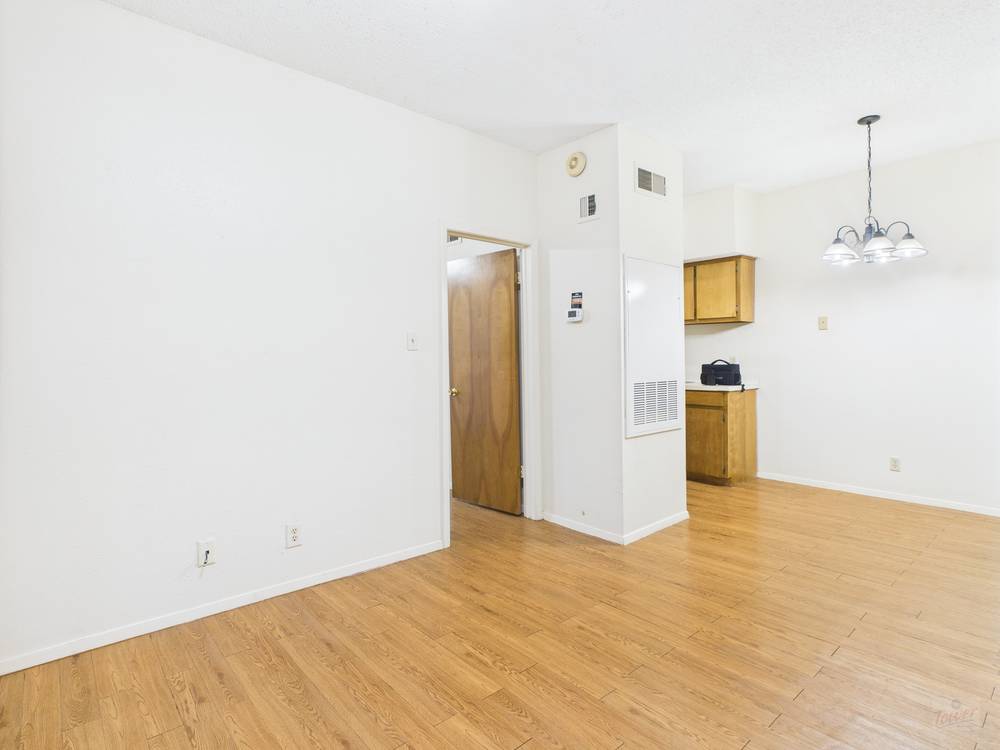 3316 Guadalupe Street, Unit 210 Austin, TX 78705 - Photo 1 of 15 a view of a kitchen with wooden floor and a ceiling fan
