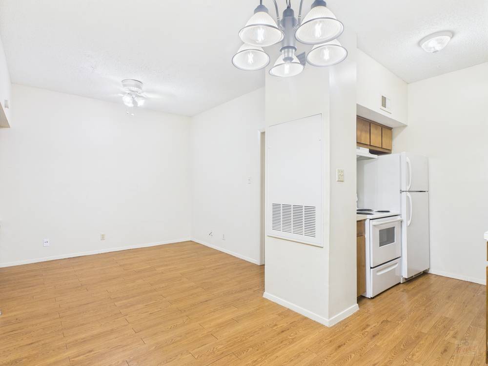 3316 Guadalupe Street, Unit 210 Austin, TX 78705 - Photo 2 of 15 a view of a kitchen with wooden cabinet and stainless steel appliances