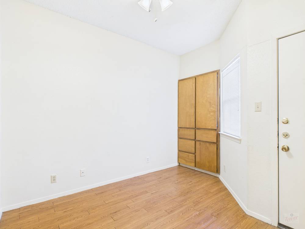 3316 Guadalupe Street, Unit 210 Austin, TX 78705 - Photo 4 of 15 a view of empty room with wooden floor and fan