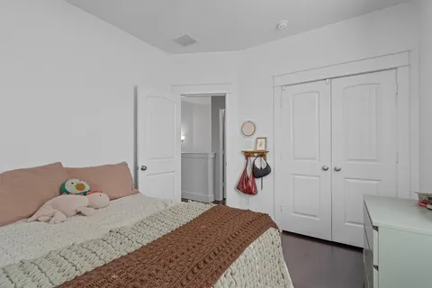a bedroom with a bed and a closet