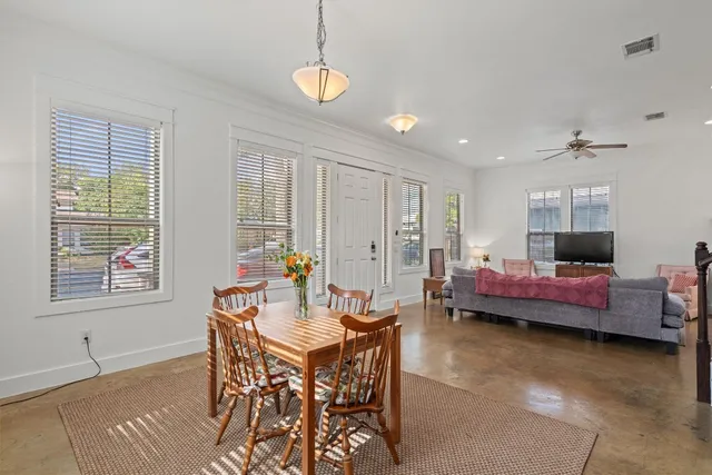 a dining room with furniture and window