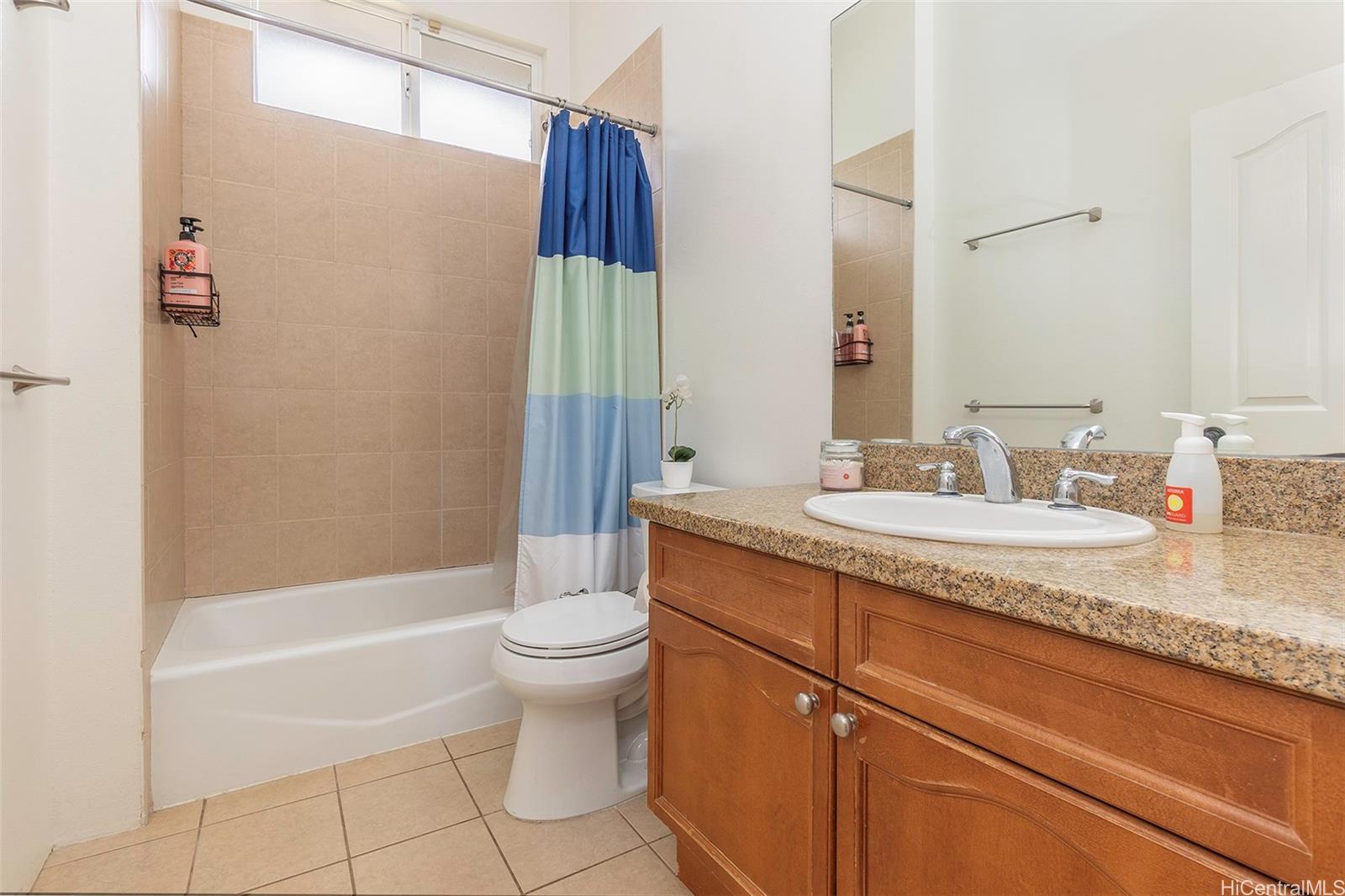 92-1087 Palahia Street, Unit B Kapolei, HI 96707 - Photo 13 of 24 a bathroom with a granite countertop sink toilet and shower