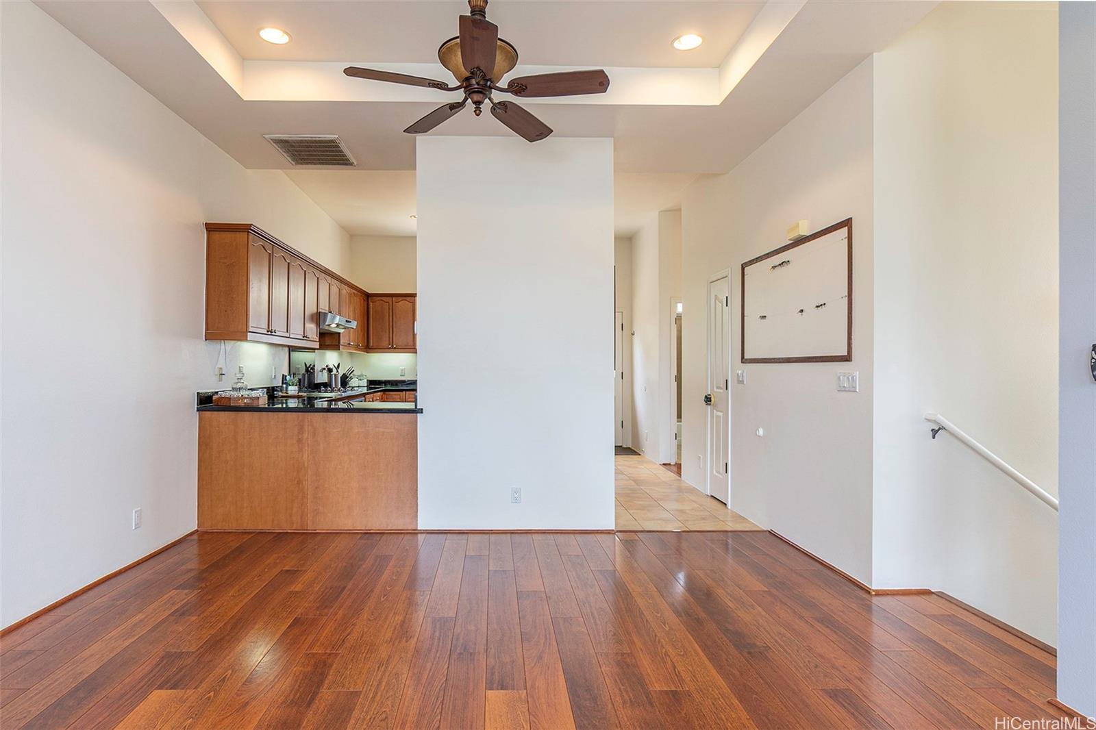 92-1087 Palahia Street, Unit B Kapolei, HI 96707 - Photo 17 of 24 a view of a kitchen with wooden floor and a ceiling fan