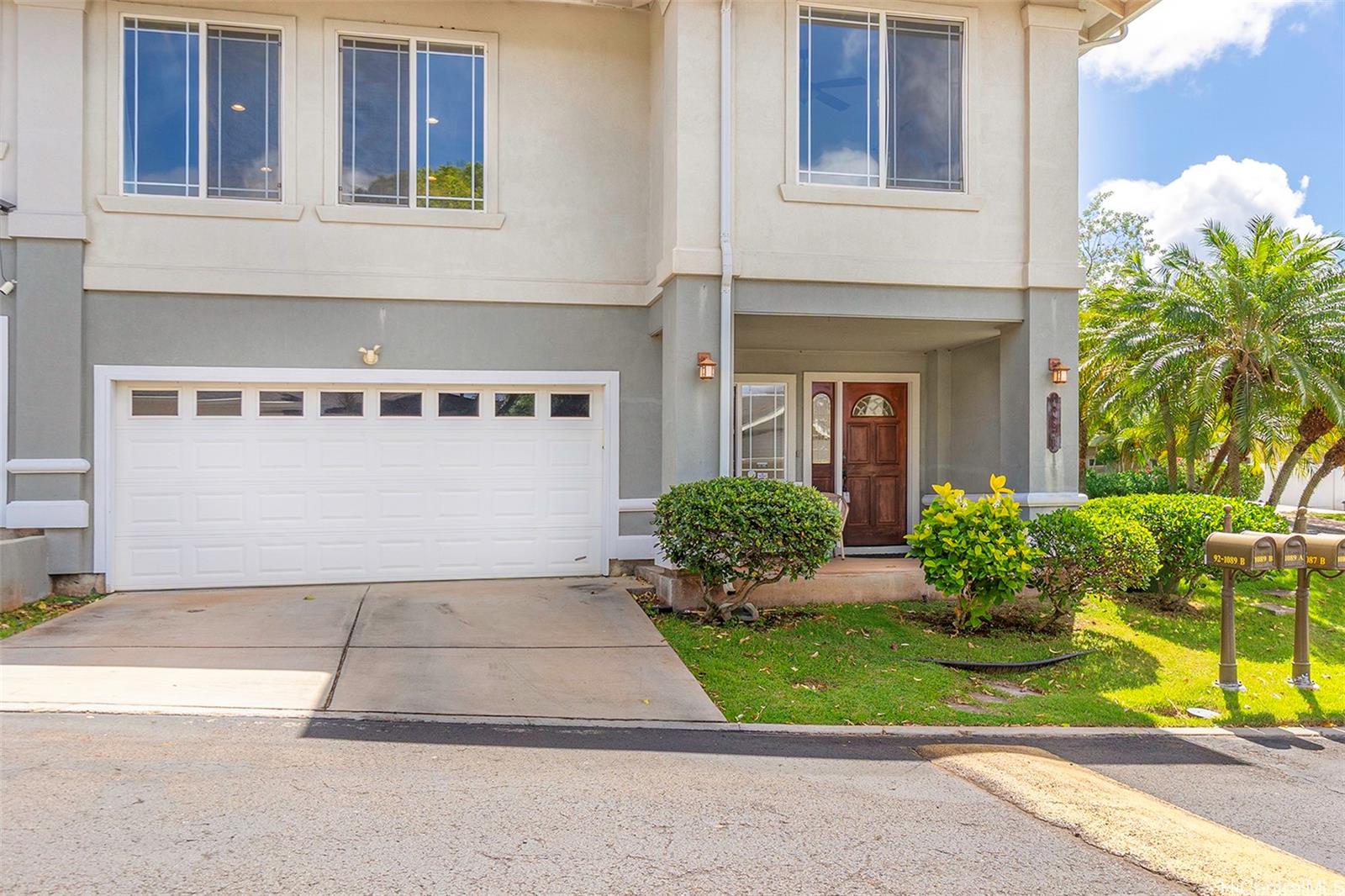 92-1087 Palahia Street, Unit B Kapolei, HI 96707 - Photo 22 of 24 a front view of a house with a yard
