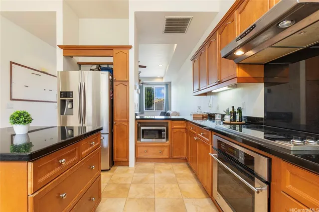 a kitchen with stainless steel appliances a sink and a refrigerator