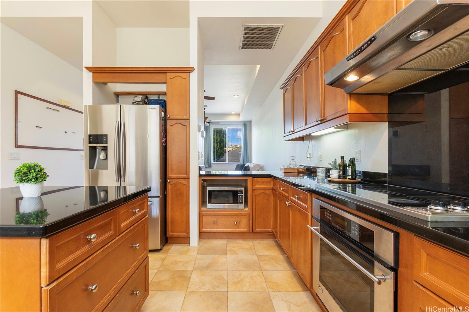 92-1087 Palahia Street, Unit B Kapolei, HI 96707 - Photo 3 of 24 a kitchen with stainless steel appliances a sink and a refrigerator