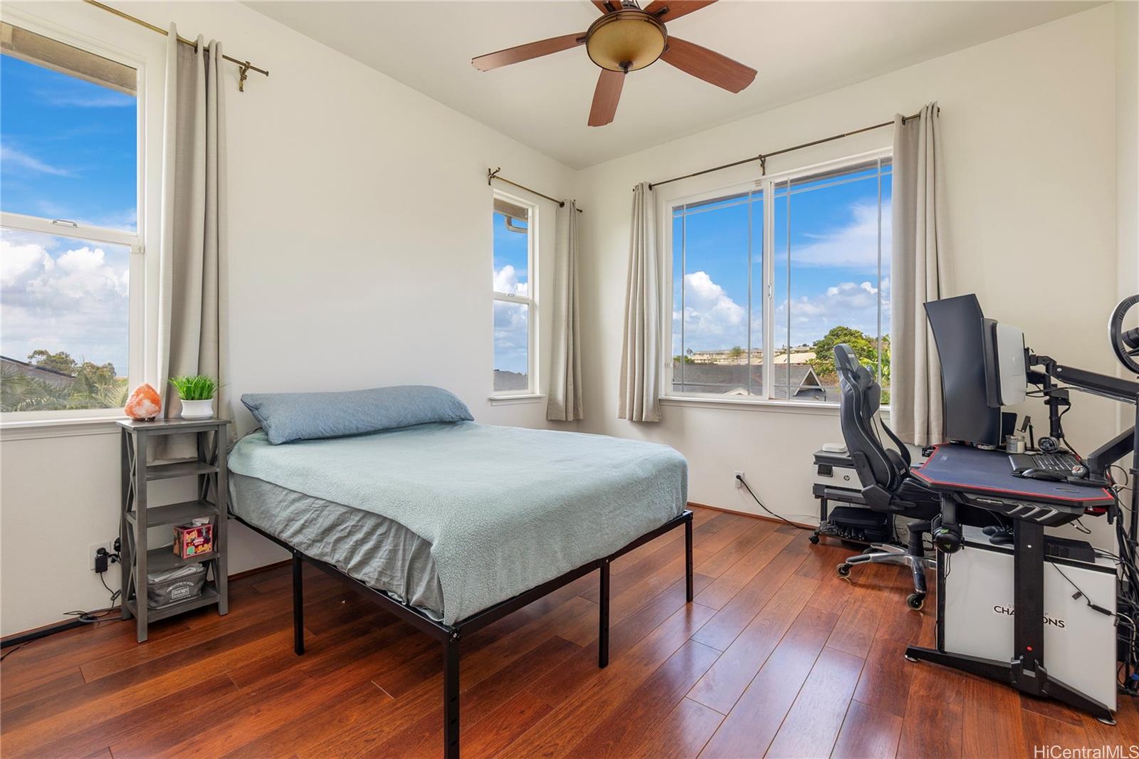 92-1087 Palahia Street, Unit B Kapolei, HI 96707 - Photo 6 of 24 a bedroom with a bed and a desk