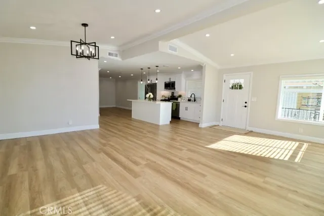 a view of kitchen with stainless steel appliances refrigerator stove and kitchen island