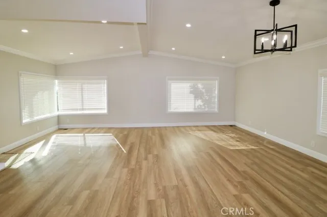 a large white kitchen with kitchen island a sink stainless steel appliances and cabinets