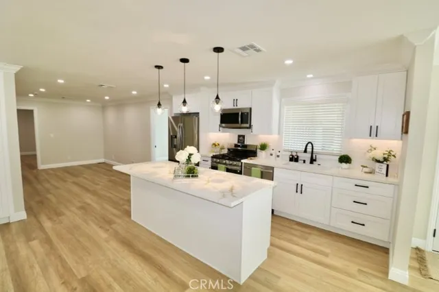 a kitchen with a sink and appliances
