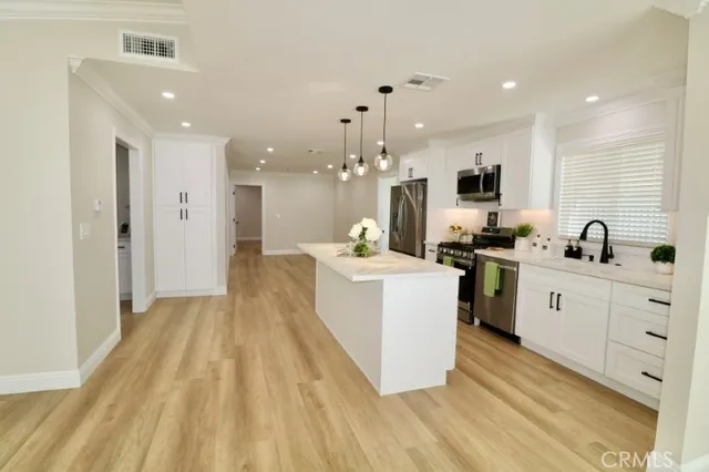 a spacious bathroom with a granite countertop sink a toilet a mirror and shower