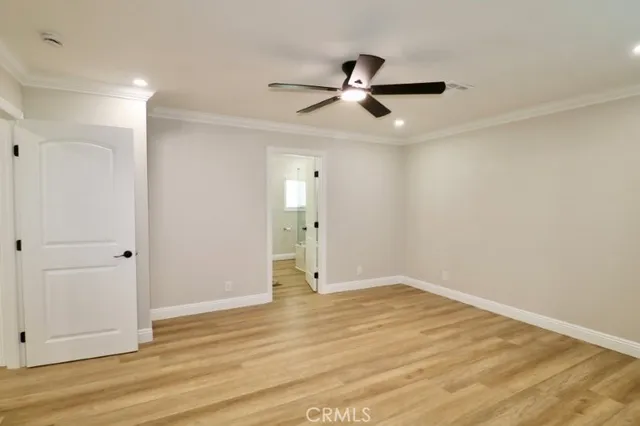 an empty room with fan and window