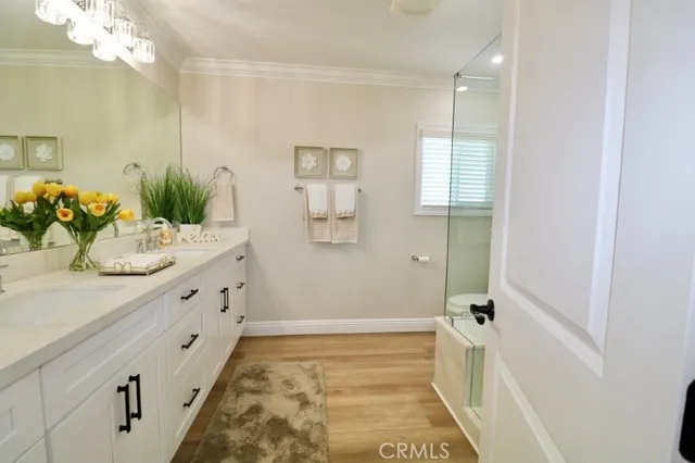 a bathroom with a double vanity sink and a mirror