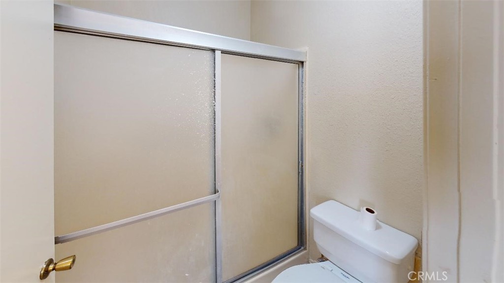 12246 Pluto Drive Victorville, CA 92392 - Photo 17 of 64 a white toilet sitting next to a shower