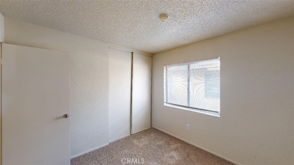 12246 Pluto Drive Victorville, CA 92392 - Photo 20 of 64 an empty room with windows