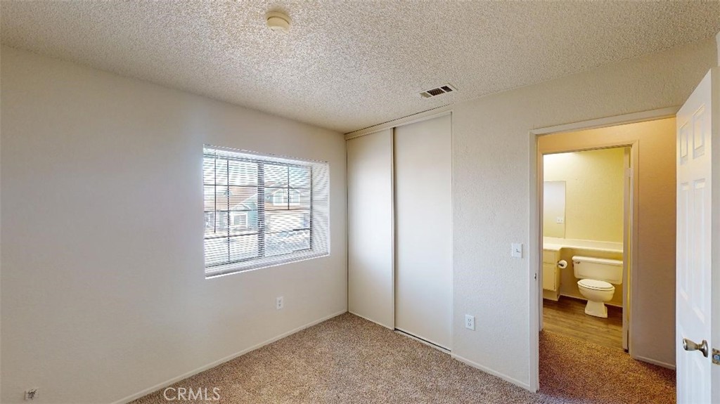 12246 Pluto Drive Victorville, CA 92392 - Photo 21 of 64 a view of a room that has a window in it