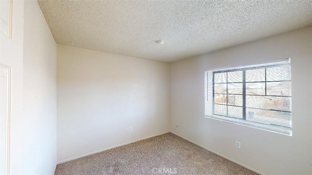 12246 Pluto Drive Victorville, CA 92392 - Photo 25 of 64 an empty room with windows