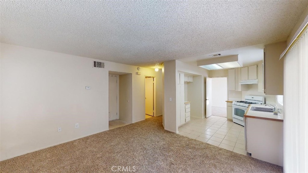 12246 Pluto Drive Victorville, CA 92392 - Photo 28 of 64 a view of a kitchen cabinets and a wooden floor