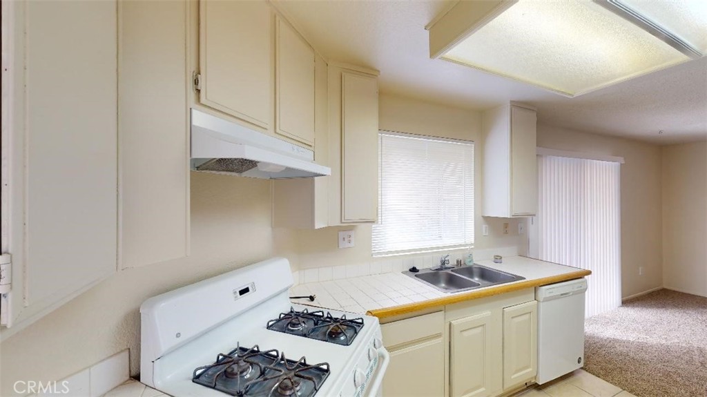 12246 Pluto Drive Victorville, CA 92392 - Photo 31 of 64 a kitchen with a sink and cabinets