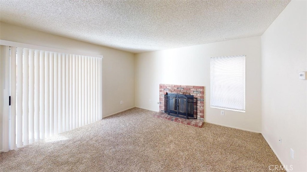12246 Pluto Drive Victorville, CA 92392 - Photo 36 of 64 an empty room with fireplace