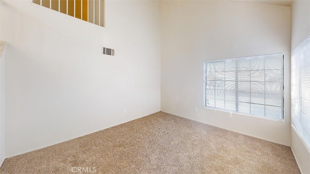 12246 Pluto Drive Victorville, CA 92392 - Photo 46 of 64 an empty room with windows