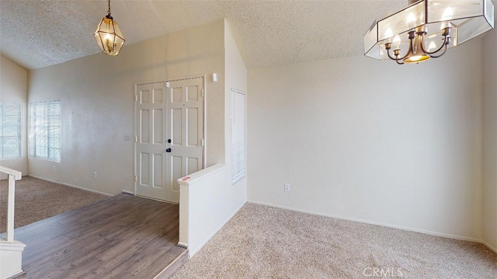 12246 Pluto Drive Victorville, CA 92392 - Photo 47 of 64 a view of an empty room with wooden floor