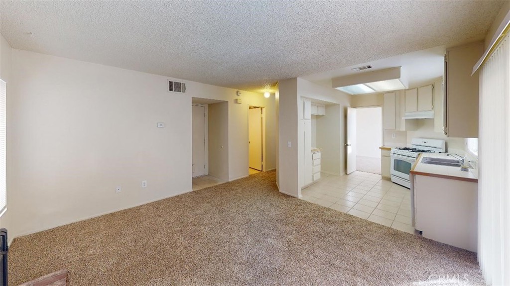 12246 Pluto Drive Victorville, CA 92392 - Photo 50 of 64 a view of a kitchen with a sink and a refrigerator
