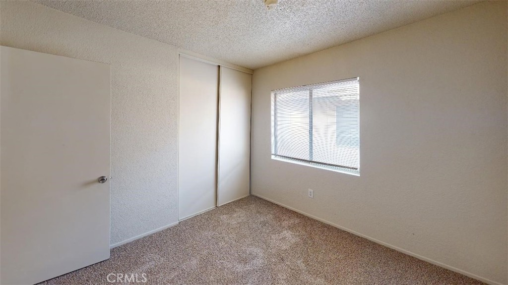 12246 Pluto Drive Victorville, CA 92392 - Photo 54 of 64 a view of an empty room with a window