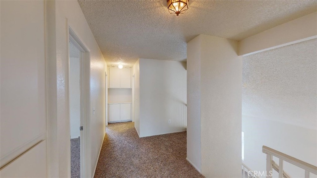 12246 Pluto Drive Victorville, CA 92392 - Photo 56 of 64 a view of a hallway with wooden floor