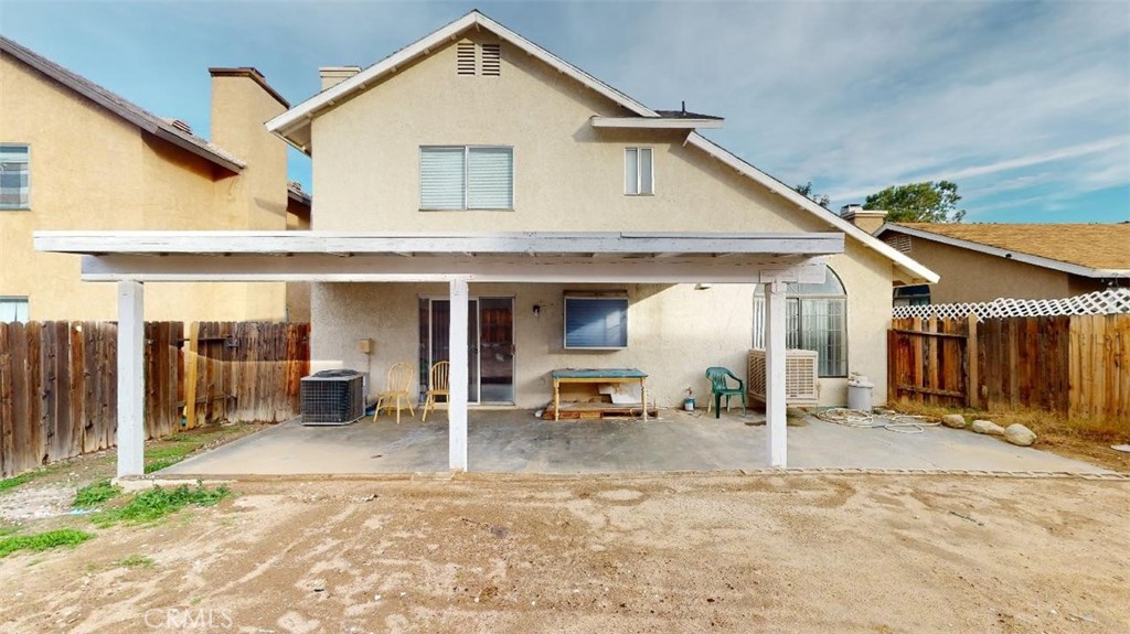 12246 Pluto Drive Victorville, CA 92392 - Photo 59 of 64 a view of a house with wooden walls and floor to ceiling window