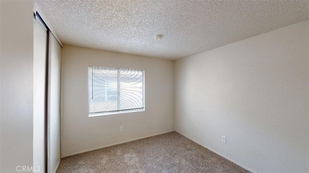 12246 Pluto Drive Victorville, CA 92392 - Photo 6 of 64 a view of an empty room with a window