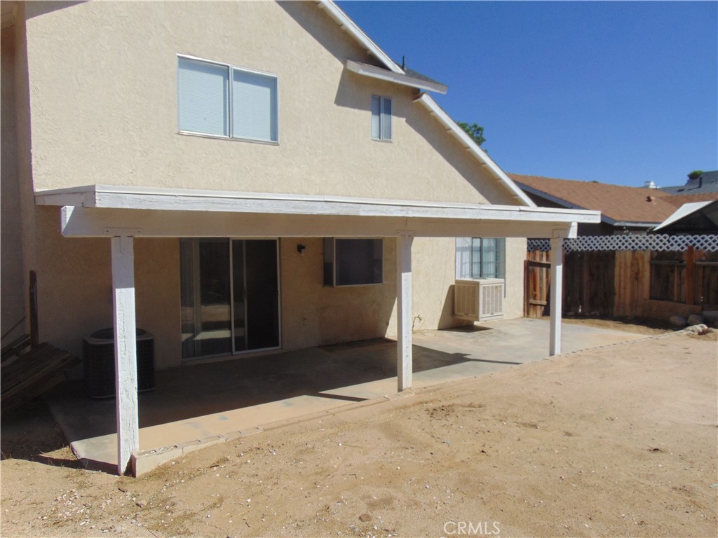 12246 Pluto Drive Victorville, CA 92392 - Photo 61 of 64 a front view of a house with a yard and garage