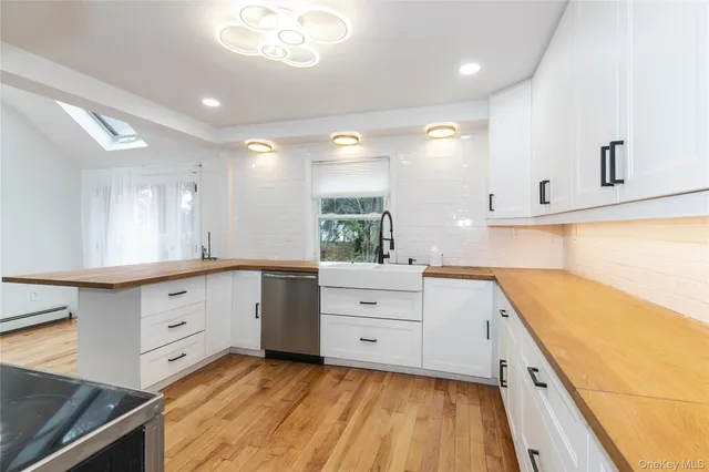 a large white kitchen with cabinets