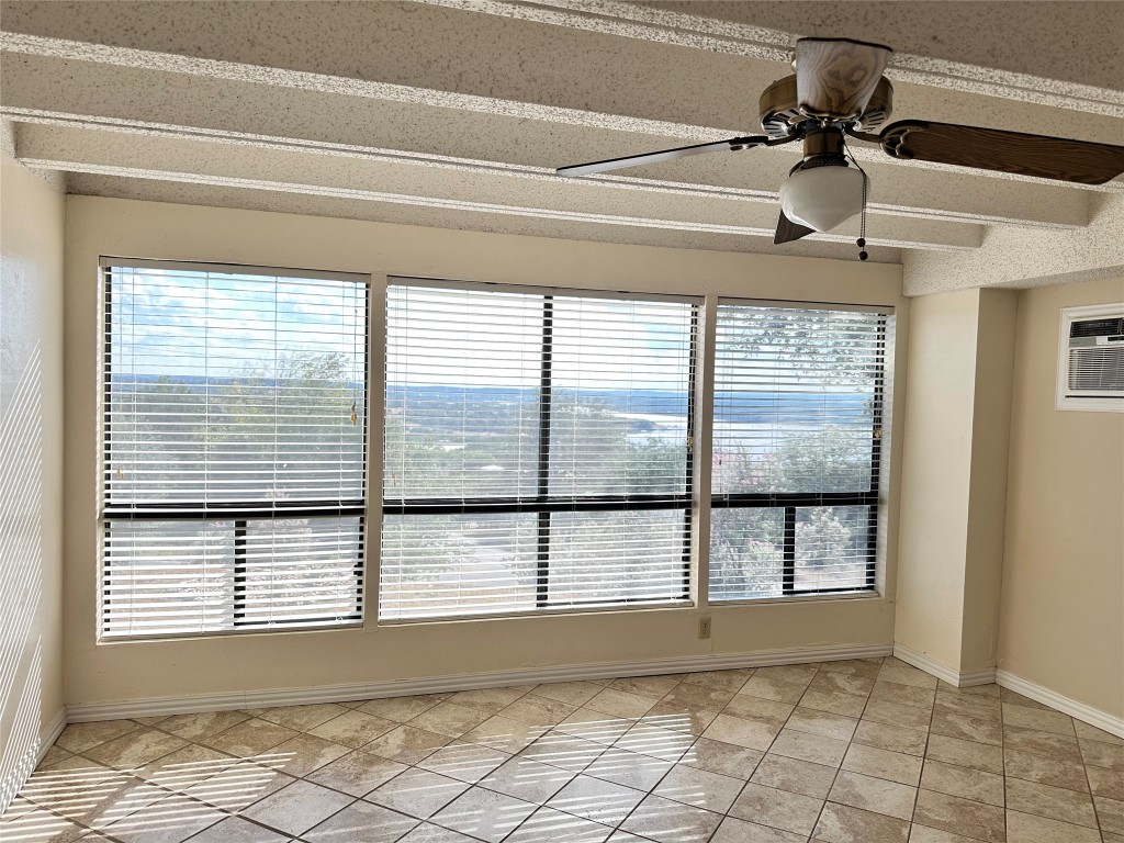 5916 Lago Vista Way, Unit B18 Lago Vista, TX 78645 - Photo 6 of 16 a view of an empty room and window ceiling fan
