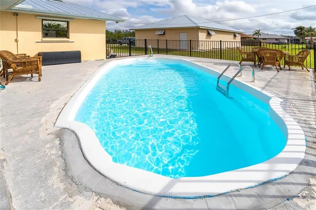 a view of a swimming pool with a lounge chairs