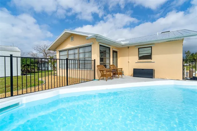 a view of a house with backyard and porch