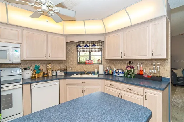a kitchen with stainless steel appliances a white cabinets and a sink