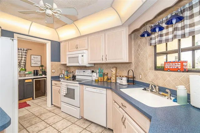 a kitchen with a sink cabinets and window