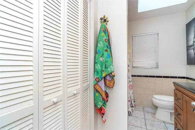 a bathroom with a granite countertop sink mirror vanity and toilet