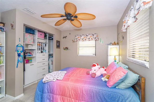 a bedroom with a bed and window