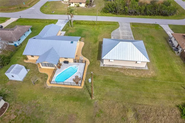 a view of an house with backyard and a tree