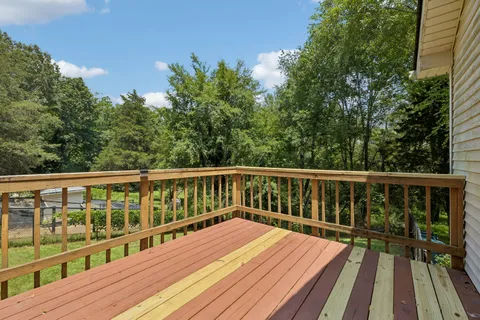 a view of balcony with wooden floor and fence