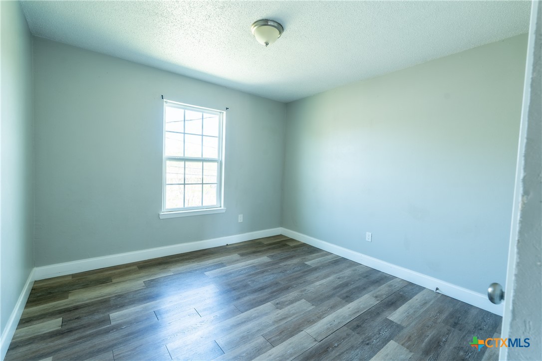 512 Sunset Lane, Unit AD Copperas Cove, TX 76522 - Photo 17 of 23 an empty room with wooden floor and windows