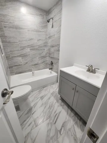 a bathroom with a bathtub and a sink