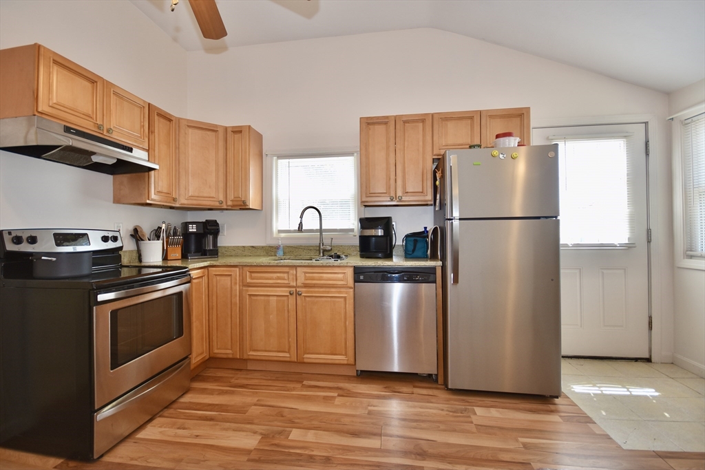 151-153 Main Street Bourne, MA 02532 - Photo 14 of 22 a kitchen with stainless steel appliances granite countertop a refrigerator sink and microwave