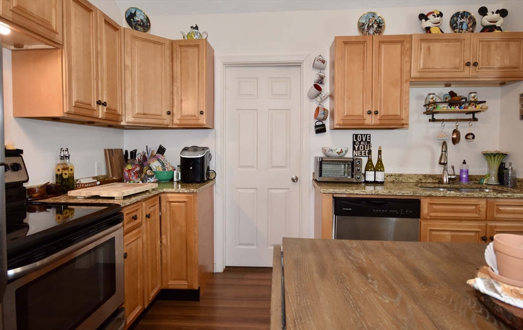 151-153 Main Street Bourne, MA 02532 - Photo 5 of 22 a kitchen with stainless steel appliances granite countertop a refrigerator and a stove top oven