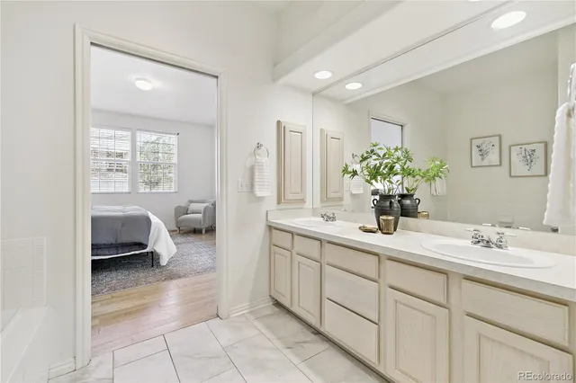 a en suite bathroom with a double sink and mirror