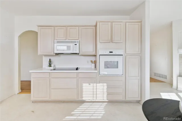 a kitchen with stainless steel appliances white cabinets and a sink