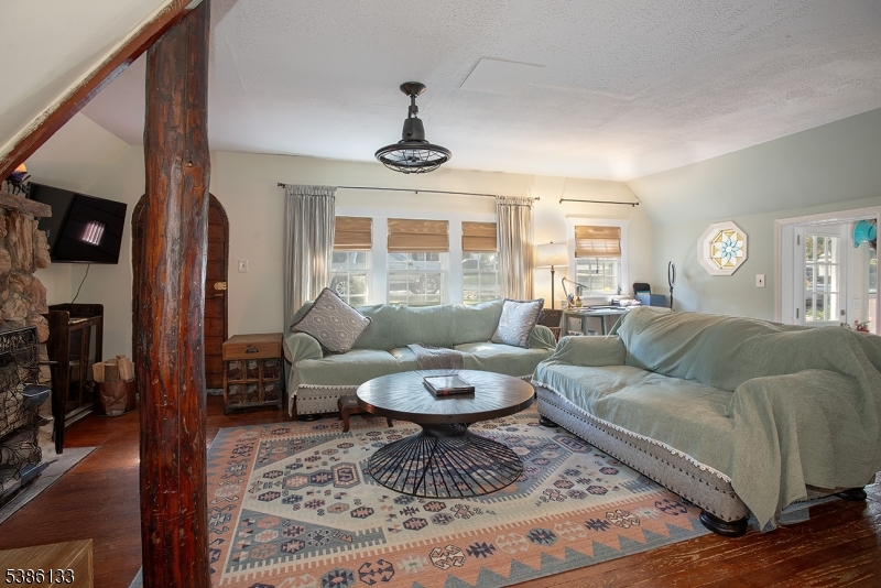 116 East Shore Trail Sparta, NJ 07871 - Photo 11 of 17 a living room with furniture a rug and a chandelier