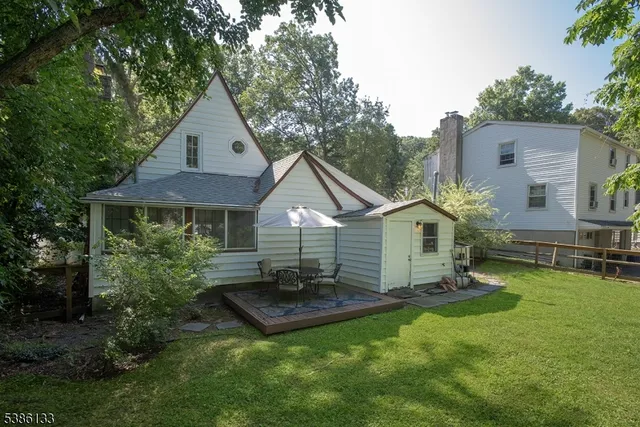 a view of a house with a yard and sitting area